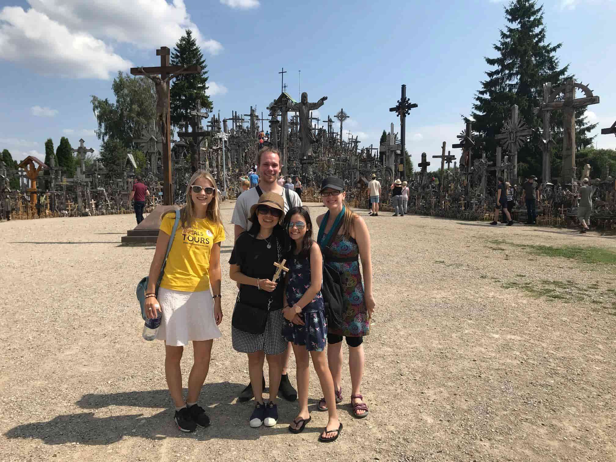 A group of tourists visiting the hill of crosses with Vilnius with Locals Tours guide Milda